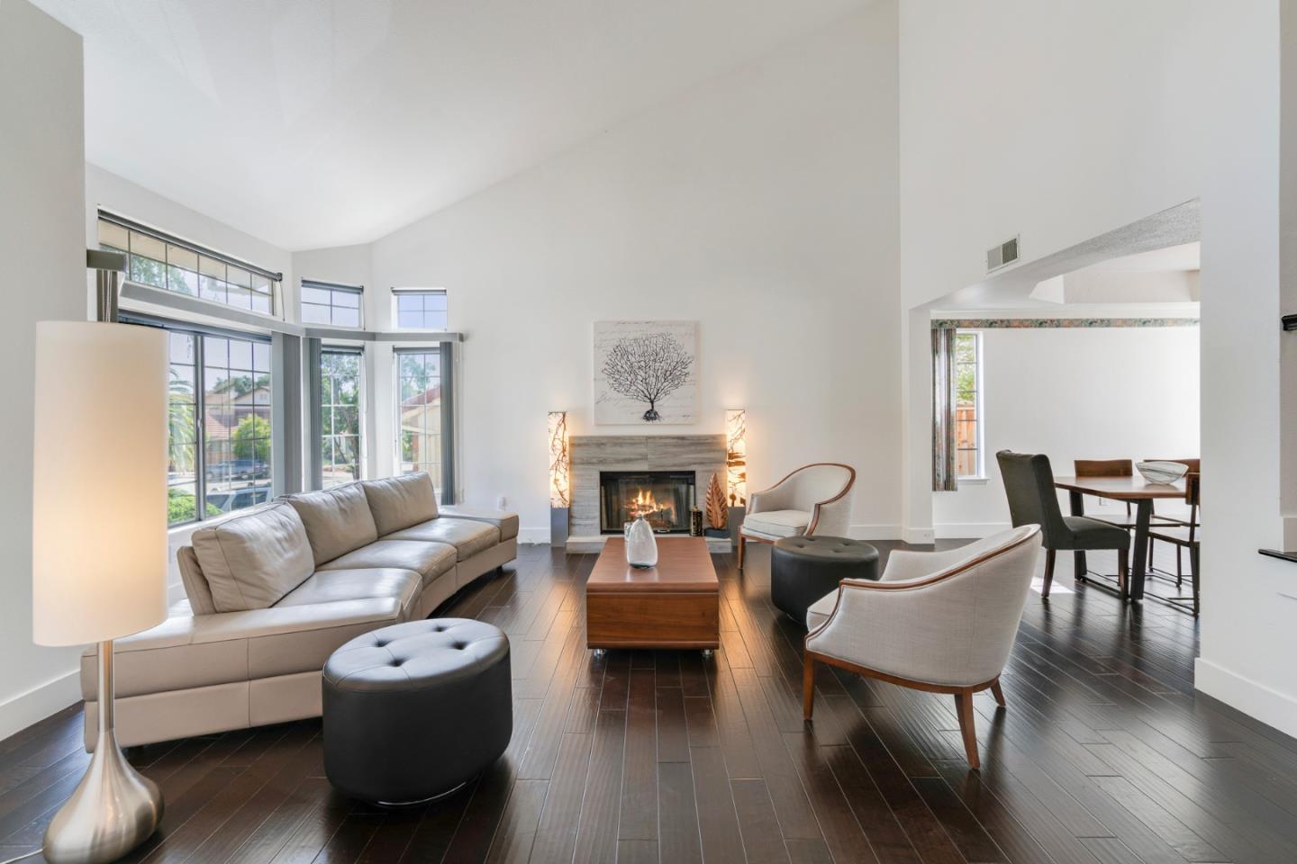2257 Glenview Drive Milpitas, CA 95035 - Photo 3 of 28 a living room with furniture a fireplace and large windows