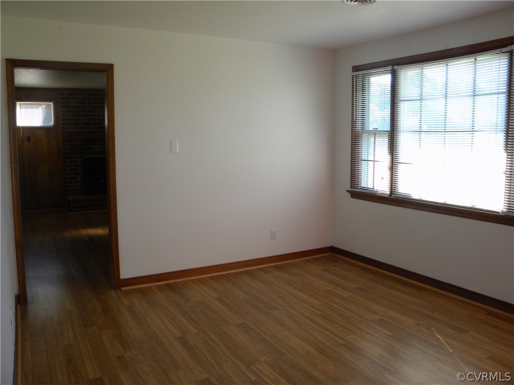 2826 New Market Road Henrico, VA 23231 - Photo 5 of 16 an empty room with wooden floor and windows