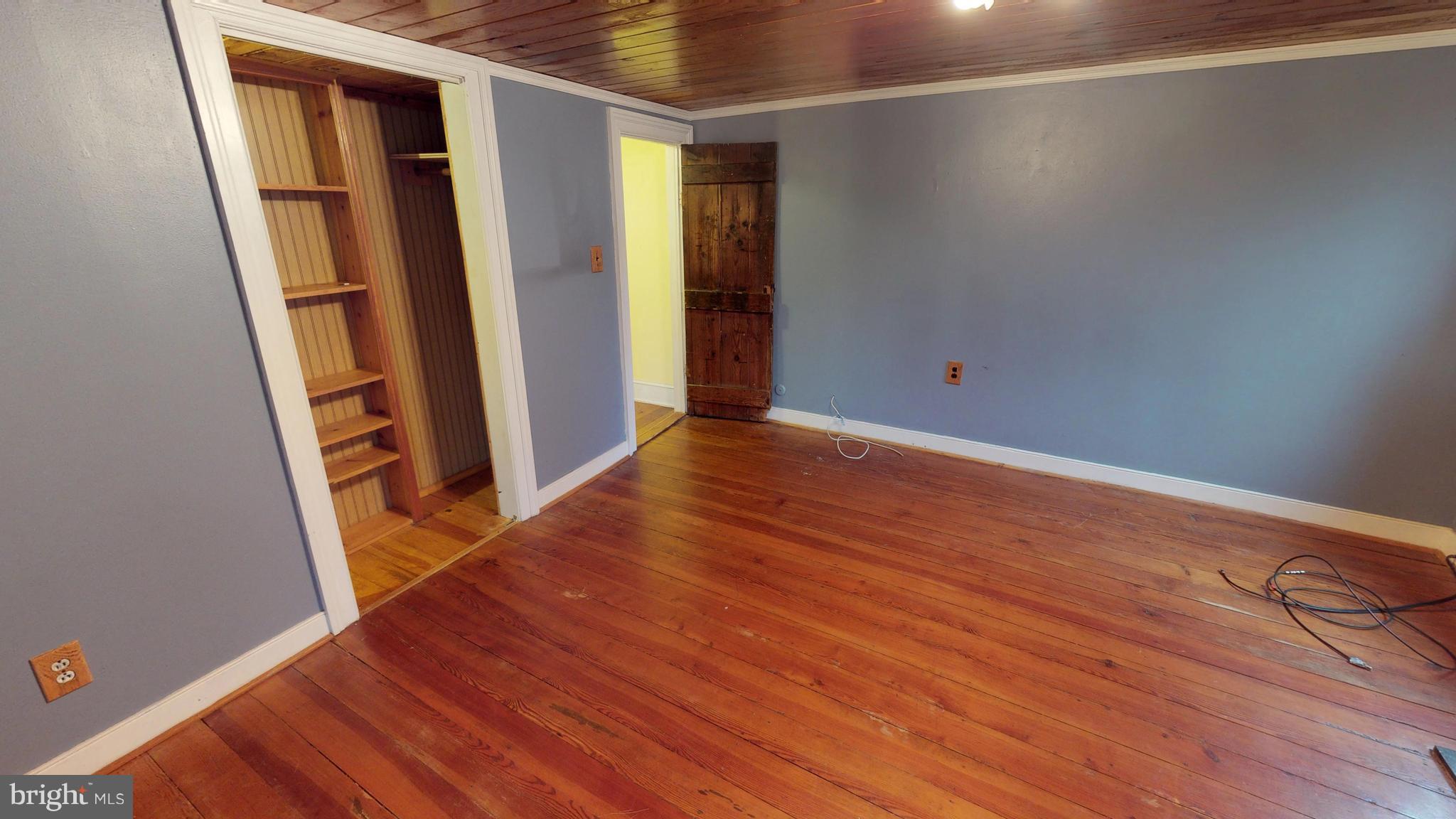 527 Hawkins Farm Road Bumpass, VA 23024 - Photo 30 of 30 an empty room with wooden floor and closet