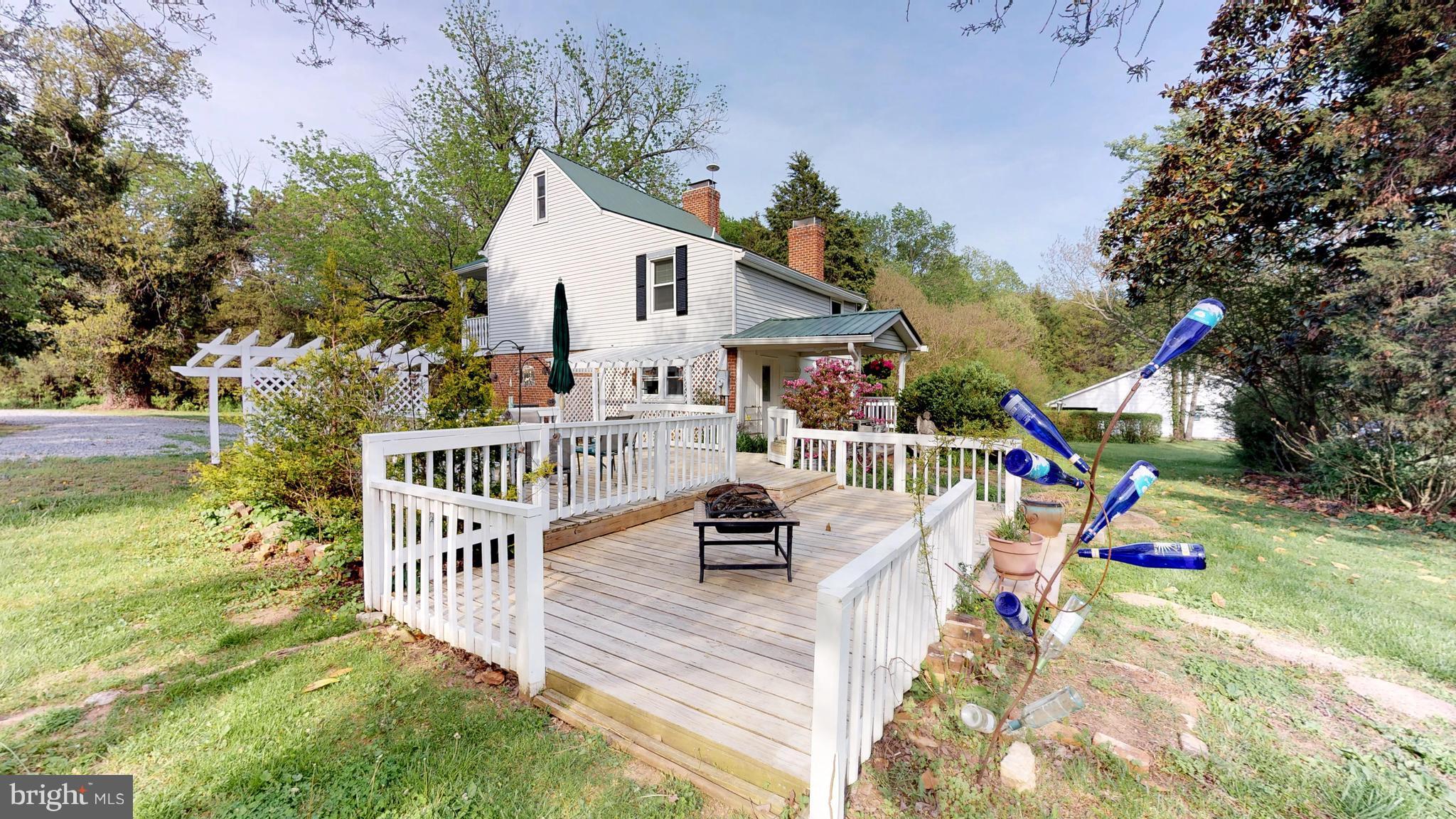 527 Hawkins Farm Road Bumpass, VA 23024 - Photo 4 of 30 a view of a patio with a table and chairs
