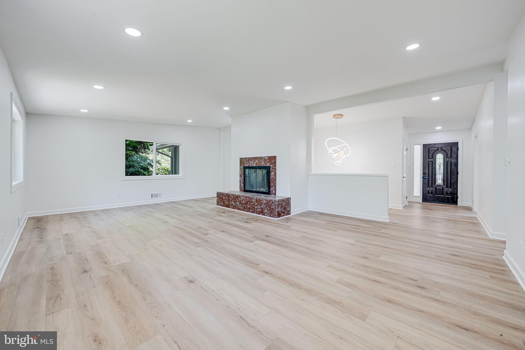 866 Canal Drive McLean, VA 22102 - Photo 5 of 41 a view of empty room with wooden floor and fireplace