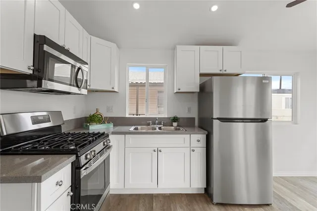 a kitchen with a stove a refrigerator and a sink