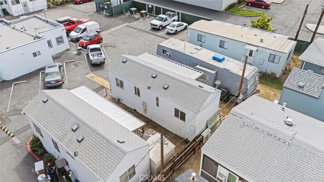 an aerial view of residential house with parking
