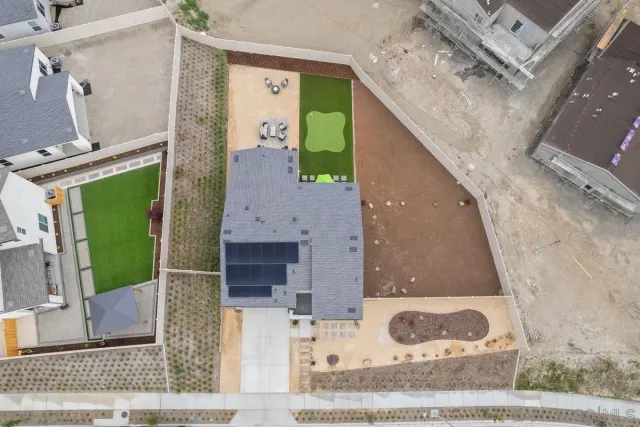 a kitchen with stainless steel appliances a stove a sink a refrigerator and white cabinets with wooden floor