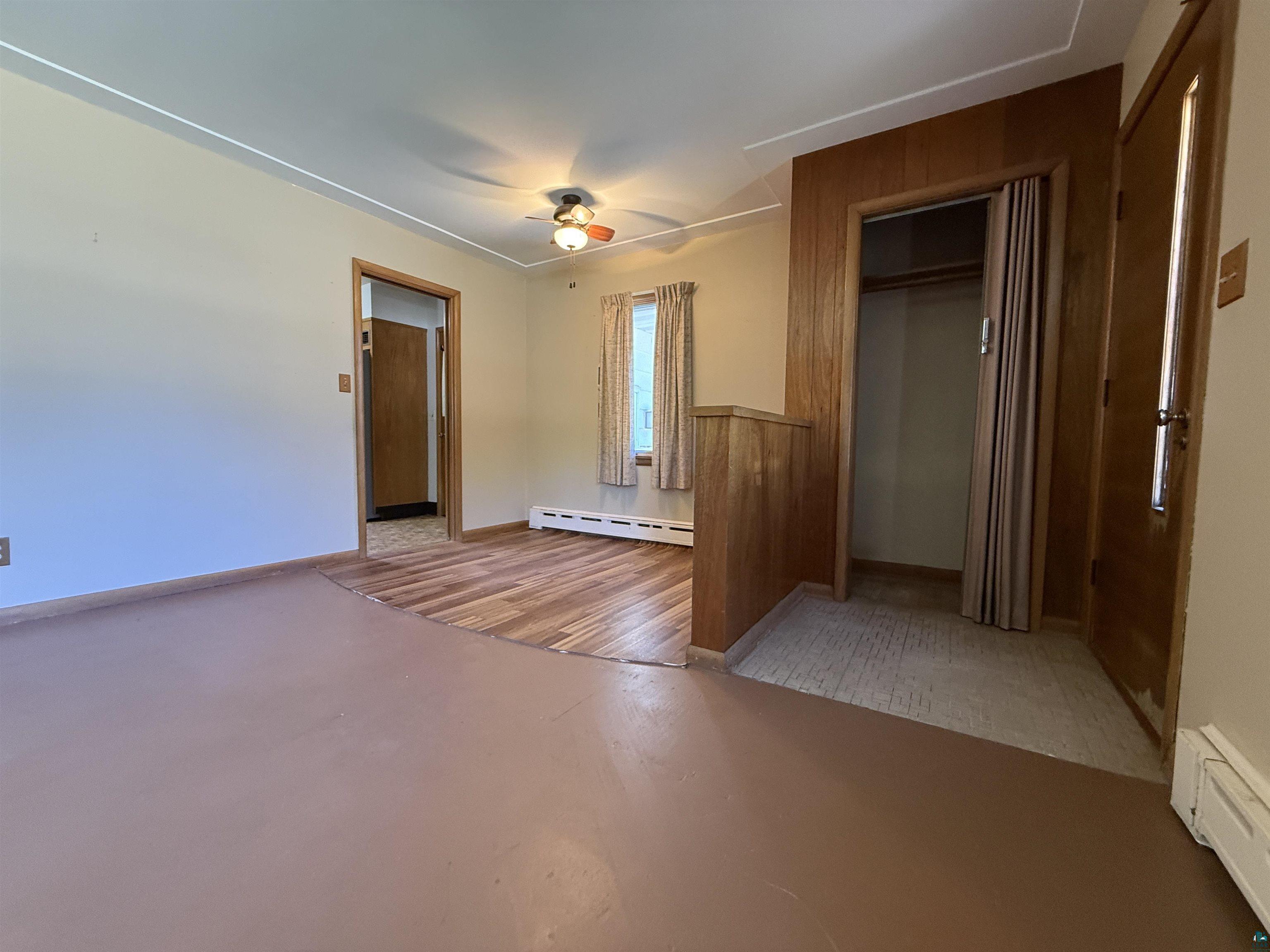607 3rd Street Northeast Chisholm, MN 55719 - Photo 4 of 32 Interior space featuring wood-finish flooring, light-toned walls, and a ceiling fan with integrated lighting