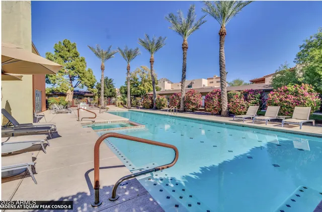 a view of a swimming pool with outdoor seating