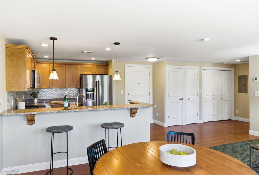 70 Great Road, Unit G Bedford, MA 01730 - Photo 8 of 15 a large kitchen with a table and chairs