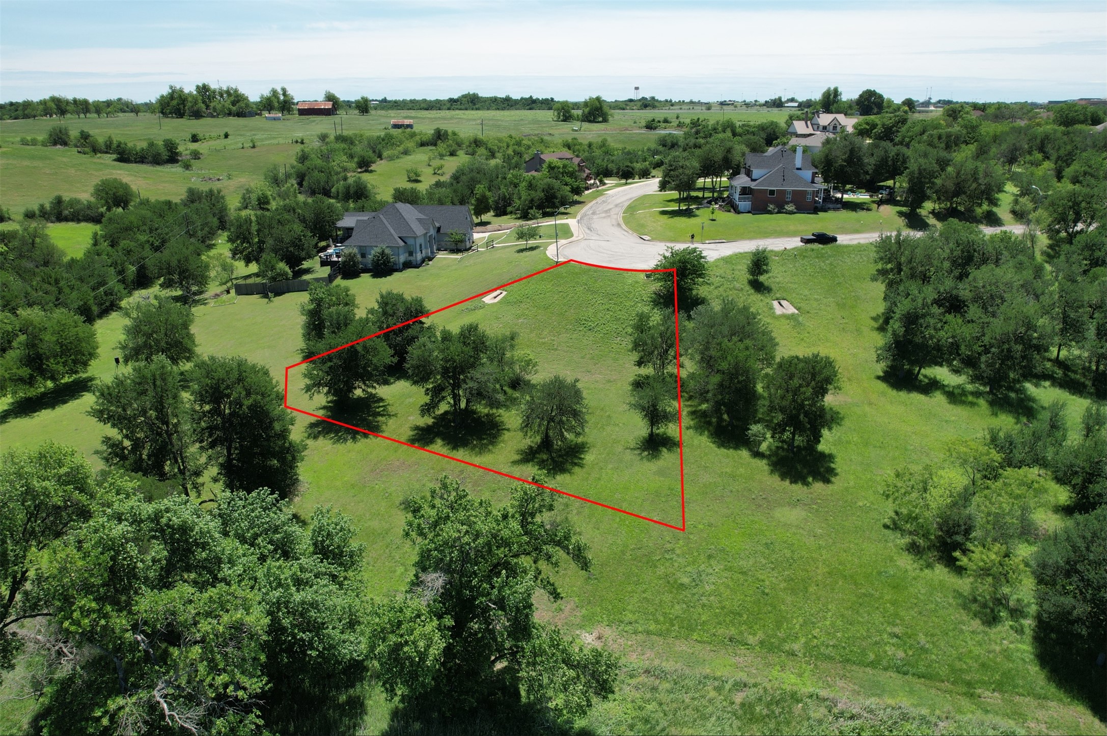 1700 Tanner Loop Taylor, TX 76574 - Photo 2 of 32 Expansive lot featuring a green lawn and mature trees