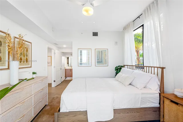 a spacious bedroom with a large bed and a window