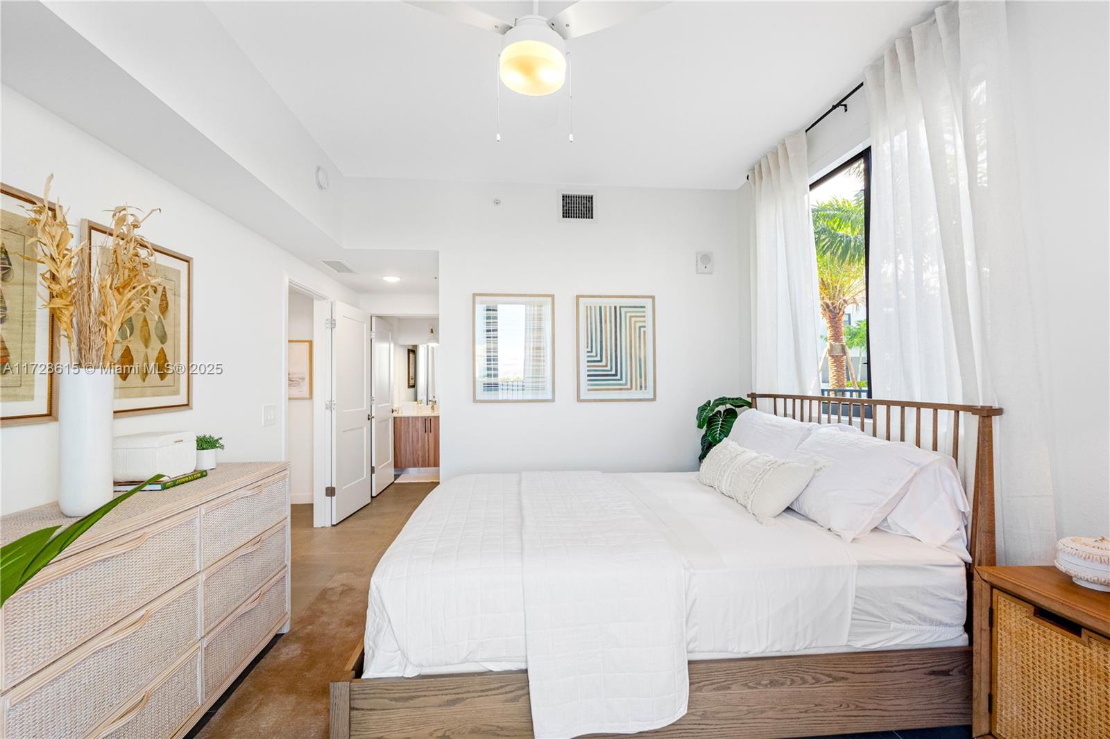 208 North Federal Highway, Unit 309 Pompano Beach, FL 33062 - Photo 2 of 29 a spacious bedroom with a large bed and a window