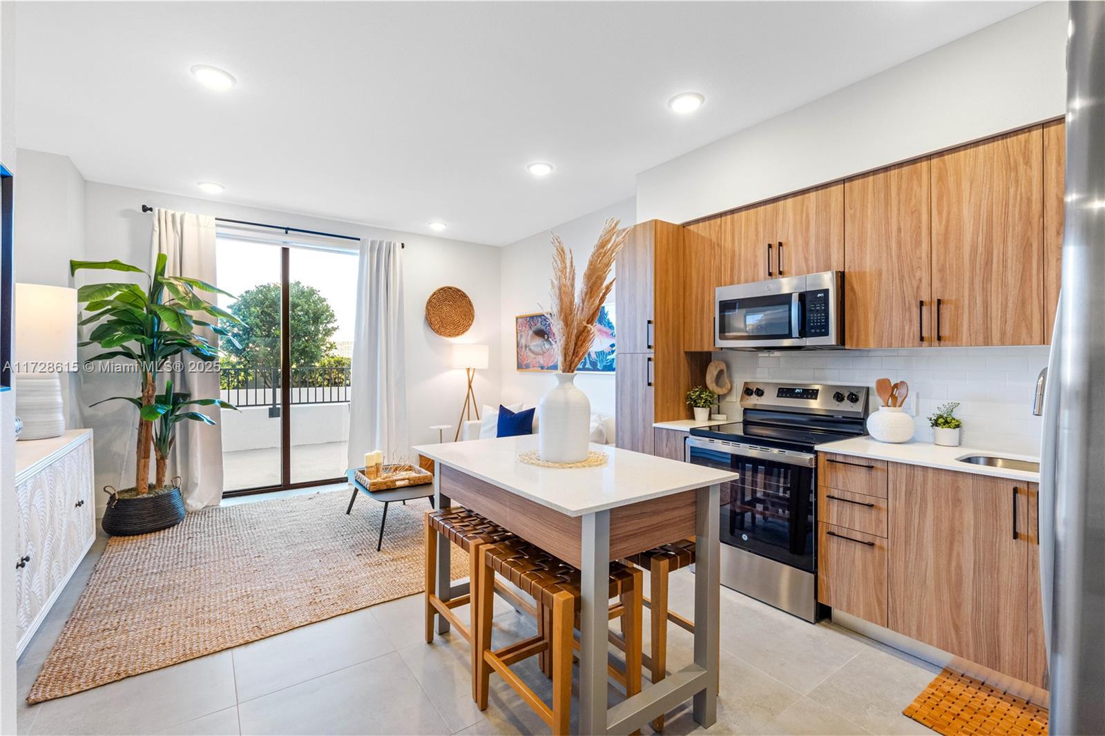 208 North Federal Highway, Unit 309 Pompano Beach, FL 33062 - Photo 5 of 29 a open kitchen with stainless steel appliances granite countertop a stove top oven a sink dishwasher a dining table and chairs with wooden floor