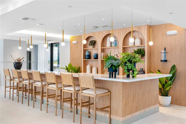 a view of a dining room with furniture and potted plant
