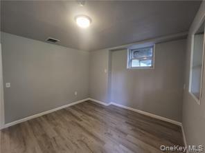 36 Houston Street Florida, NY 10921 - Photo 32 of 39 an empty room with wooden floor and windows