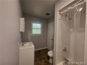 36 Houston Street Florida, NY 10921 - Photo 33 of 39 a bathroom with a granite countertop sink and a toilet
