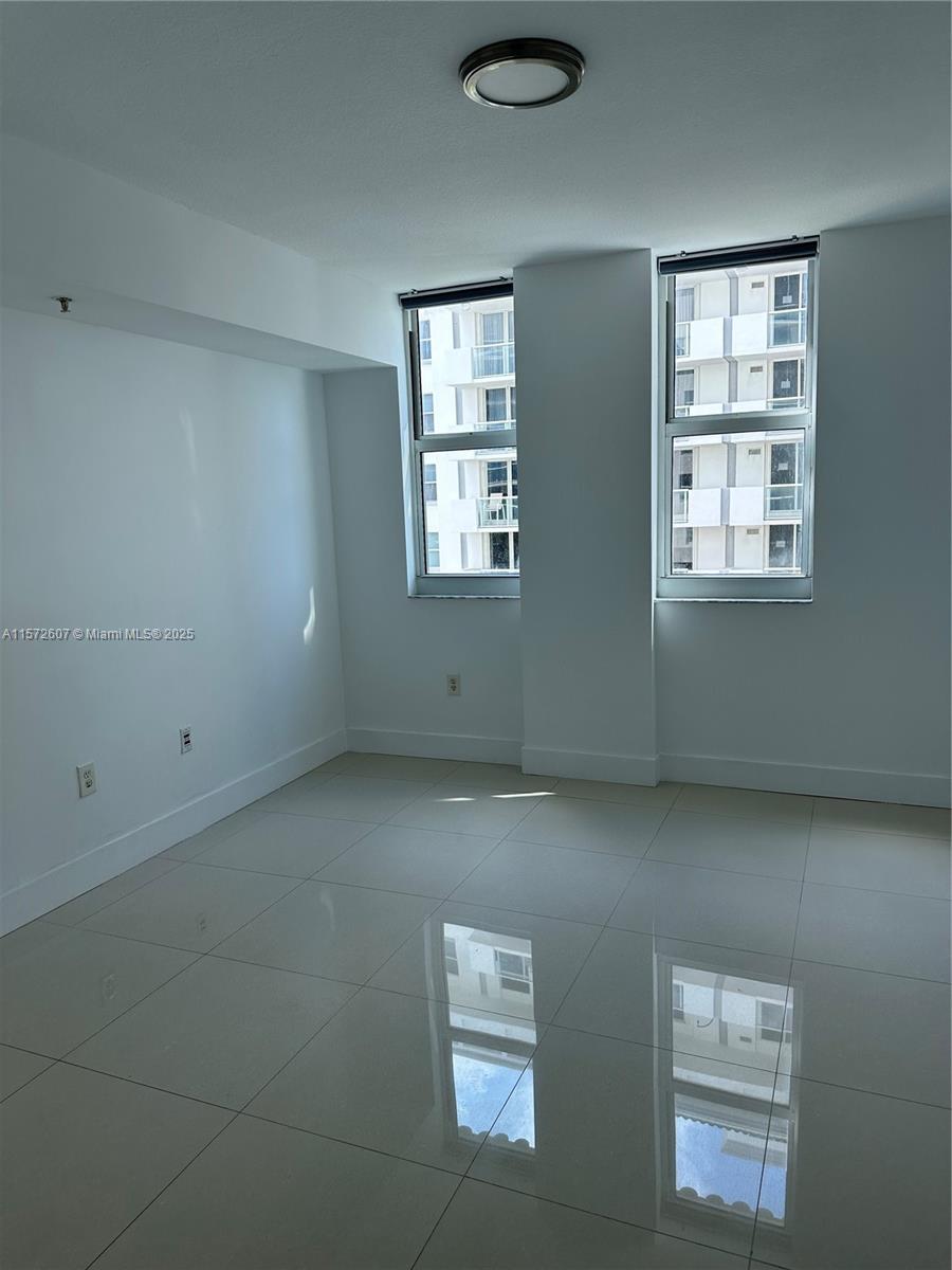 9201 Collins Avenue, Unit 524 Surfside, FL 33154 - Photo 13 of 20 a view of an empty room with windows