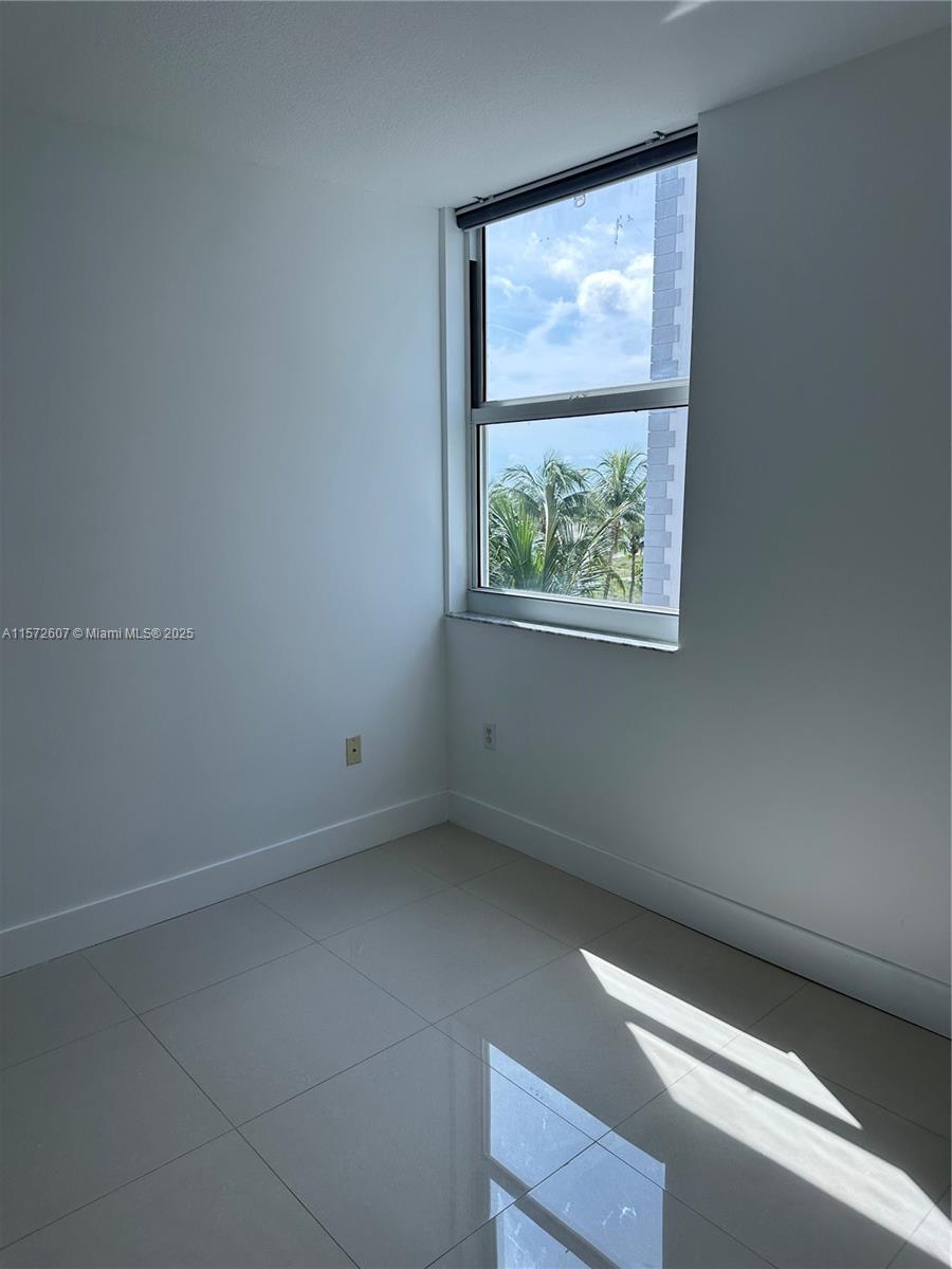 9201 Collins Avenue, Unit 524 Surfside, FL 33154 - Photo 16 of 20 an empty room with windows