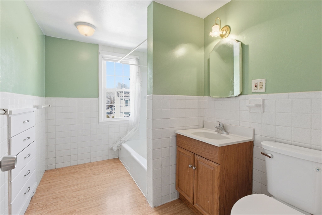 143 Commonwealth Avenue Worcester, MA 01604 - Photo 25 of 35 a bathroom with a sink a toilet and mirror
