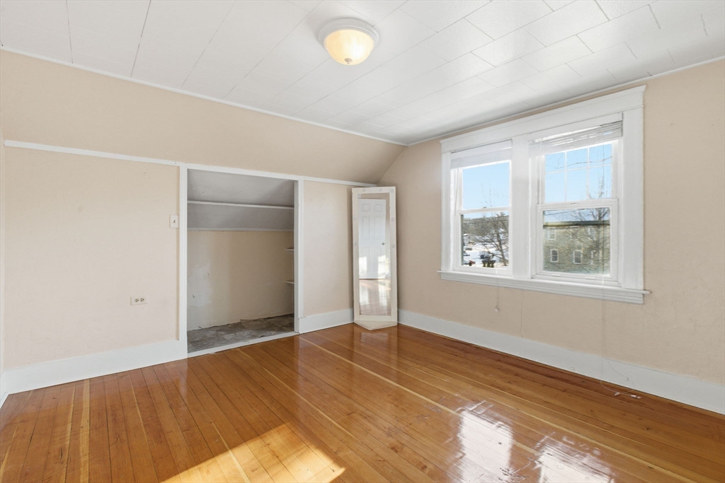 143 Commonwealth Avenue Worcester, MA 01604 - Photo 28 of 35 an empty room with wooden floor and windows