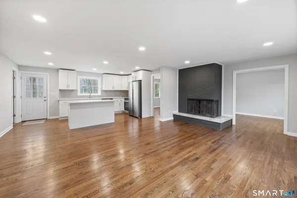 a view of a kitchen with a sink and a fireplace