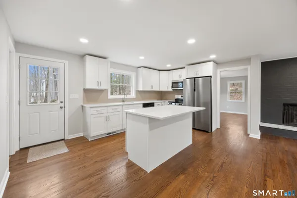 a kitchen with white cabinets and stainless steel appliances