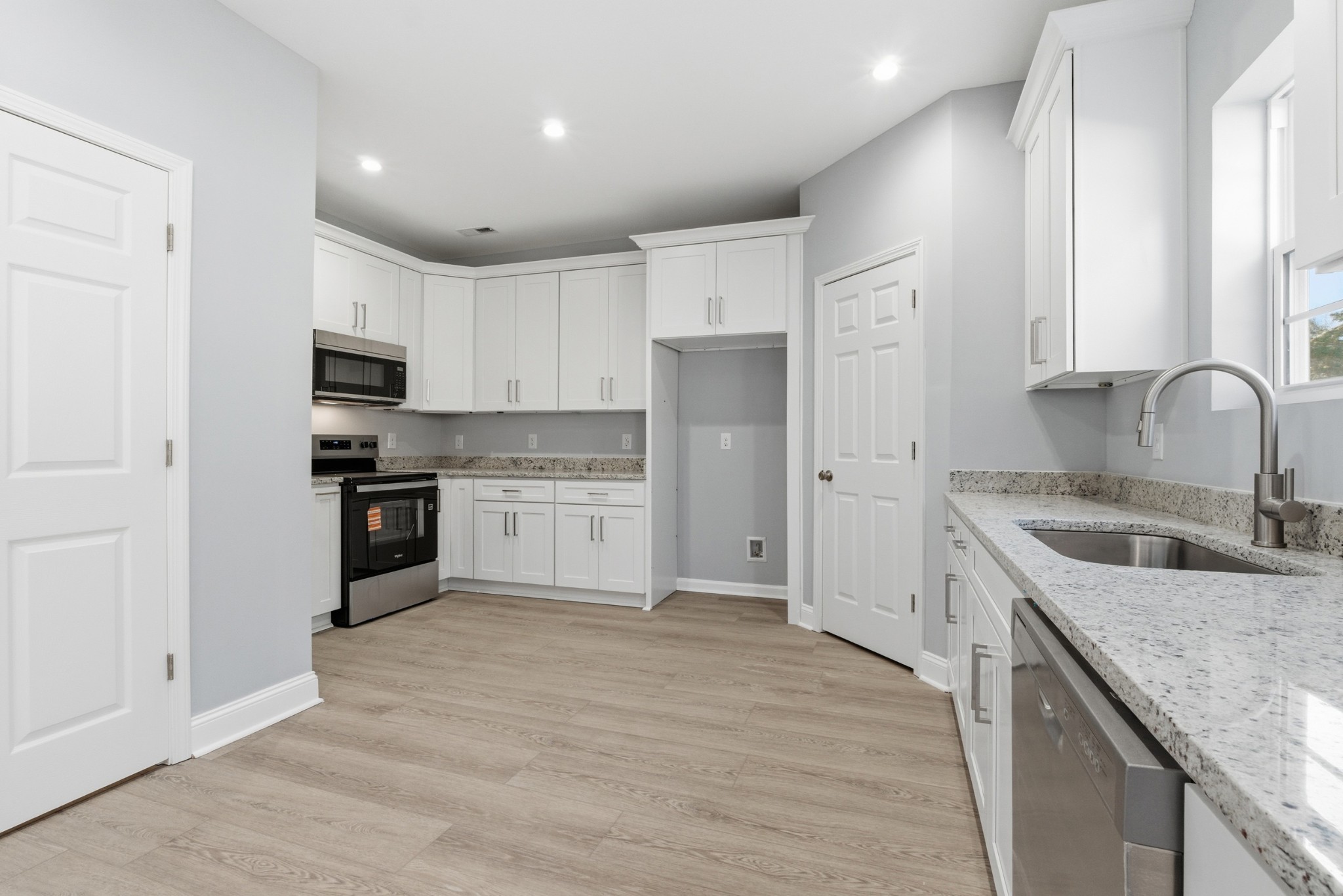 4741 Longbranch Antioch, TN 37013 - Photo 18 of 39 a kitchen with granite countertop a sink stove and refrigerator