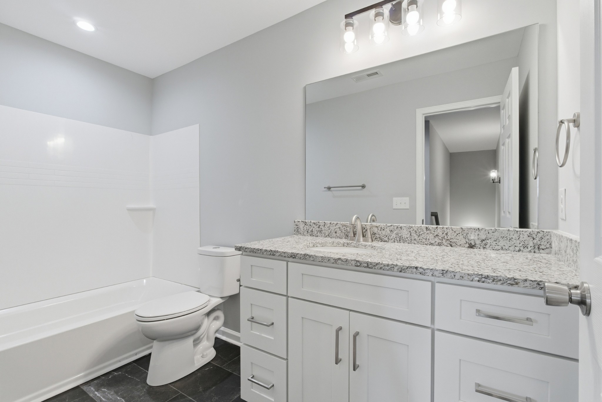 4741 Longbranch Antioch, TN 37013 - Photo 28 of 39 a bathroom with a granite countertop toilet sink and mirror