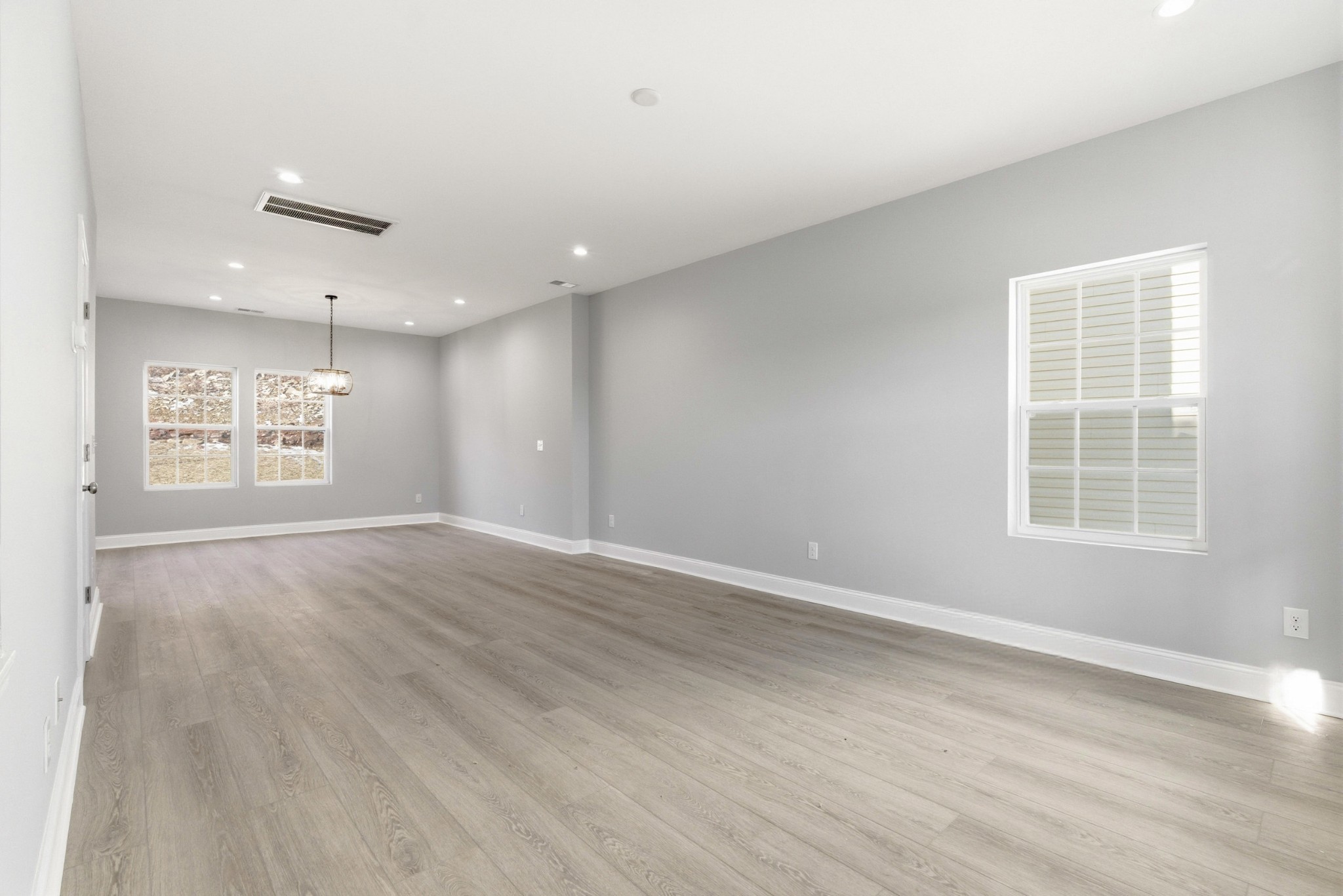 4741 Longbranch Antioch, TN 37013 - Photo 4 of 39 an empty room with wooden floor cabinet and windows