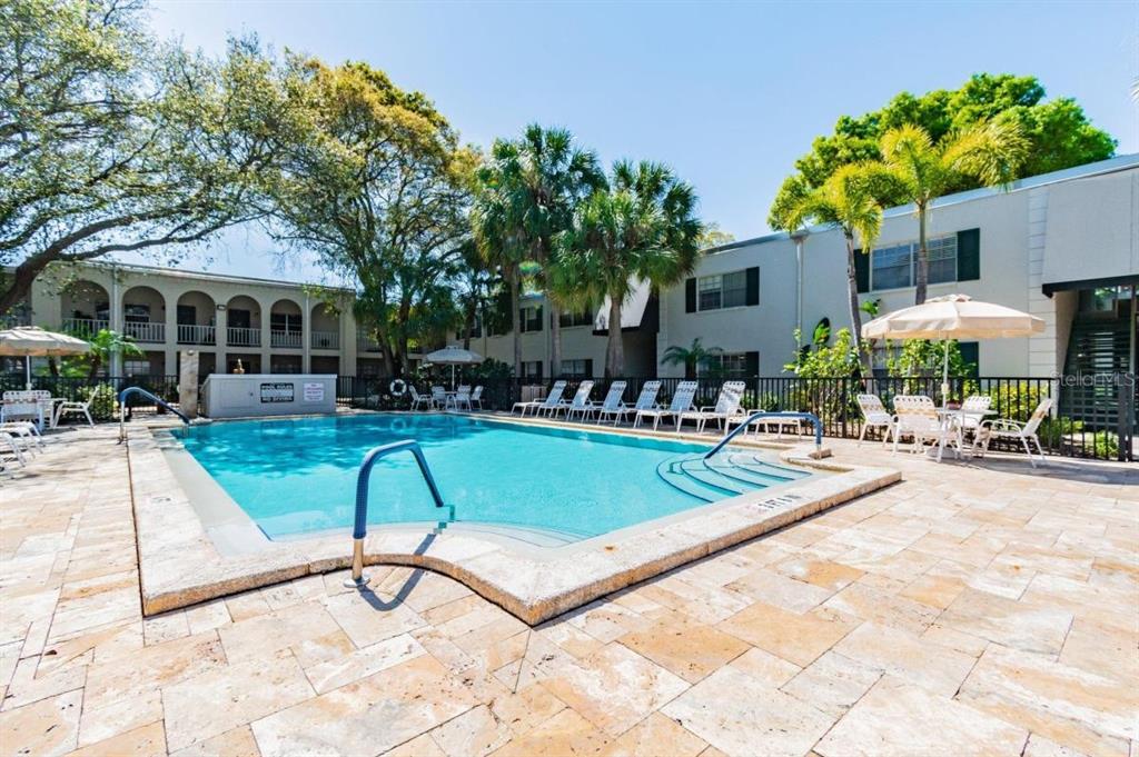 4335 Aegean Drive, Unit 108A Tampa, FL 33611 - Photo 11 of 16 a view of a house with swimming pool and sitting area