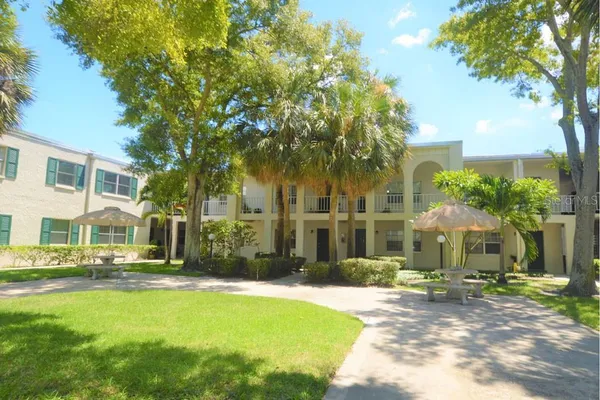 a front view of a house with swimming pool having outdoor seating