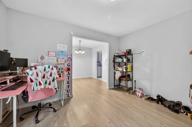 a view of a workspace with furniture and wooden floor