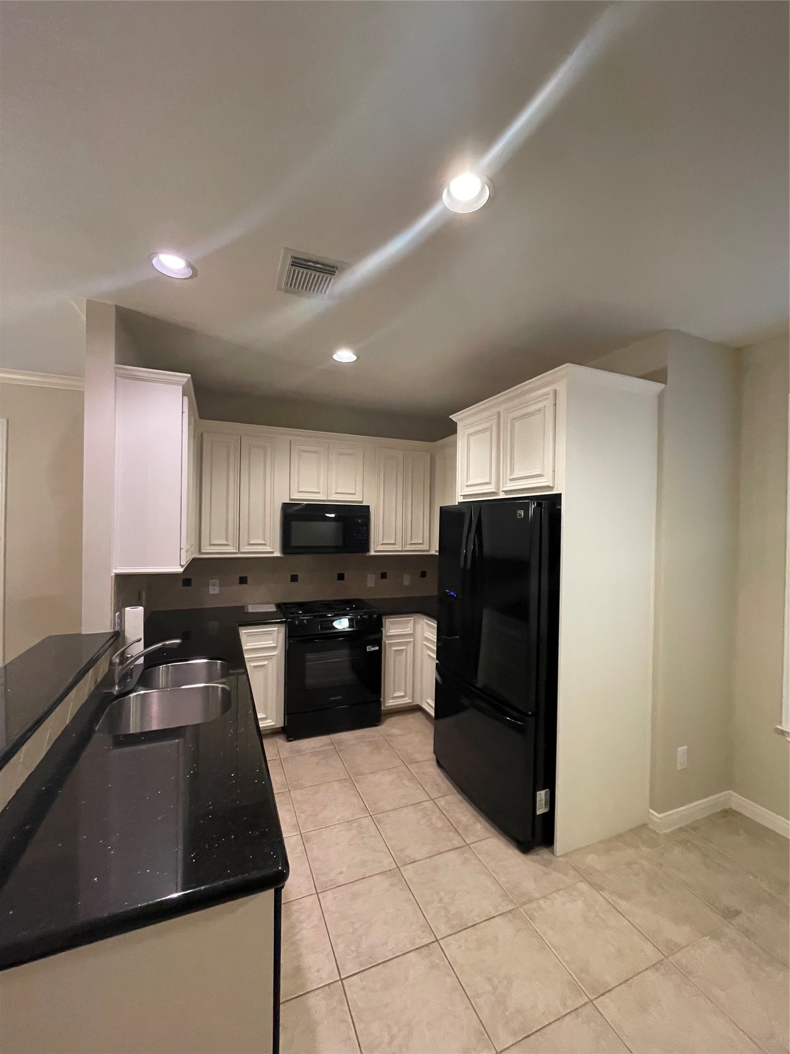 1040 La Rue Street Houston, TX 77019 - Photo 23 of 29 a kitchen with a refrigerator and a sink
