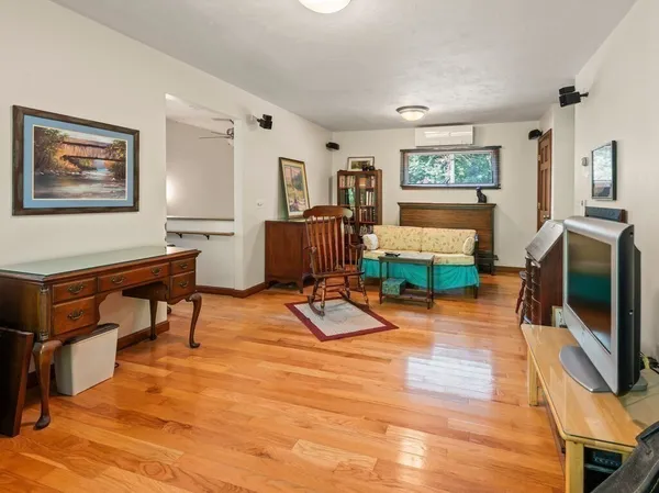 a living room with furniture a flat screen tv and a dining table