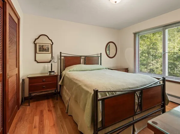 a bed sitting in a bedroom next to a window