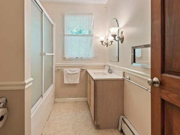 a view of a bathroom with a sink and mirror