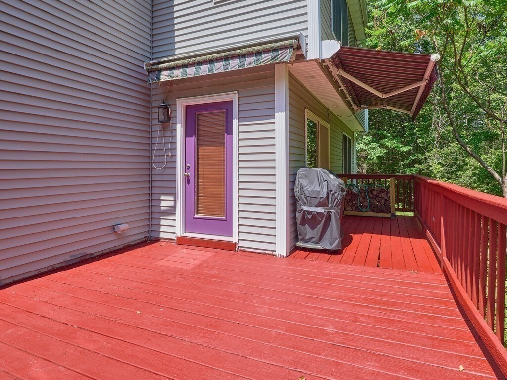 189 Maple Avenue Rutland, MA 01543 - Photo 21 of 27 a backyard of a house with barbeque oven and wooden floor