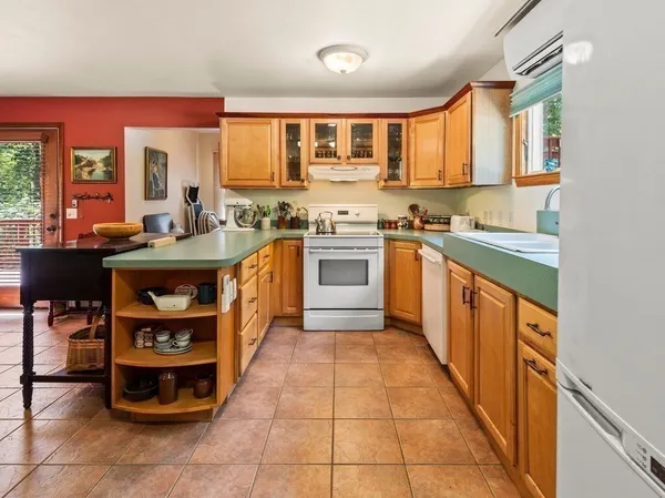 a kitchen with stainless steel appliances granite countertop a stove top oven a sink dishwasher and cabinets