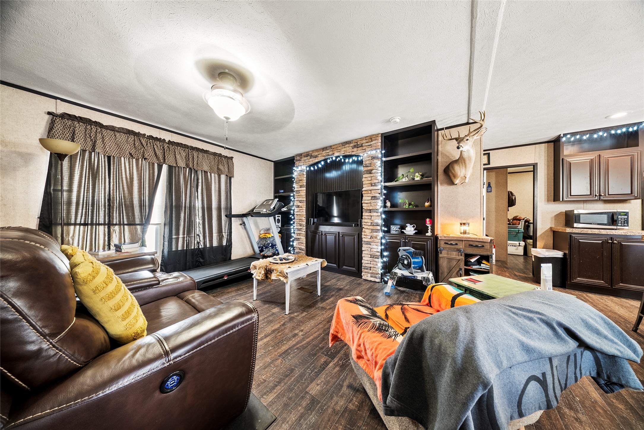 5101 County Road 463 Elgin, TX 78621 - Photo 21 of 38 a living room with furniture a fireplace and a large window