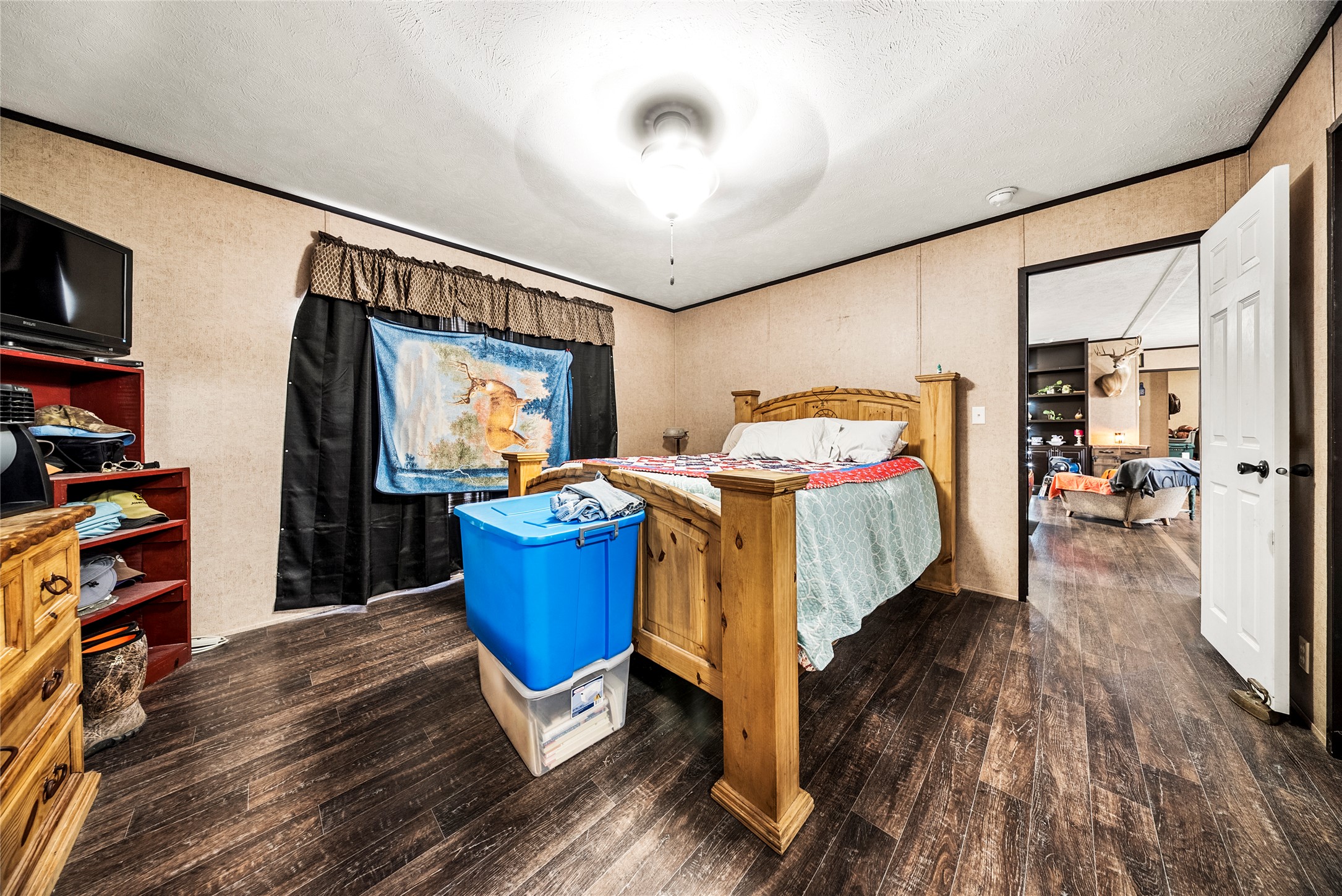 5101 County Road 463 Elgin, TX 78621 - Photo 26 of 38 a bedroom with a bed and a flat screen tv