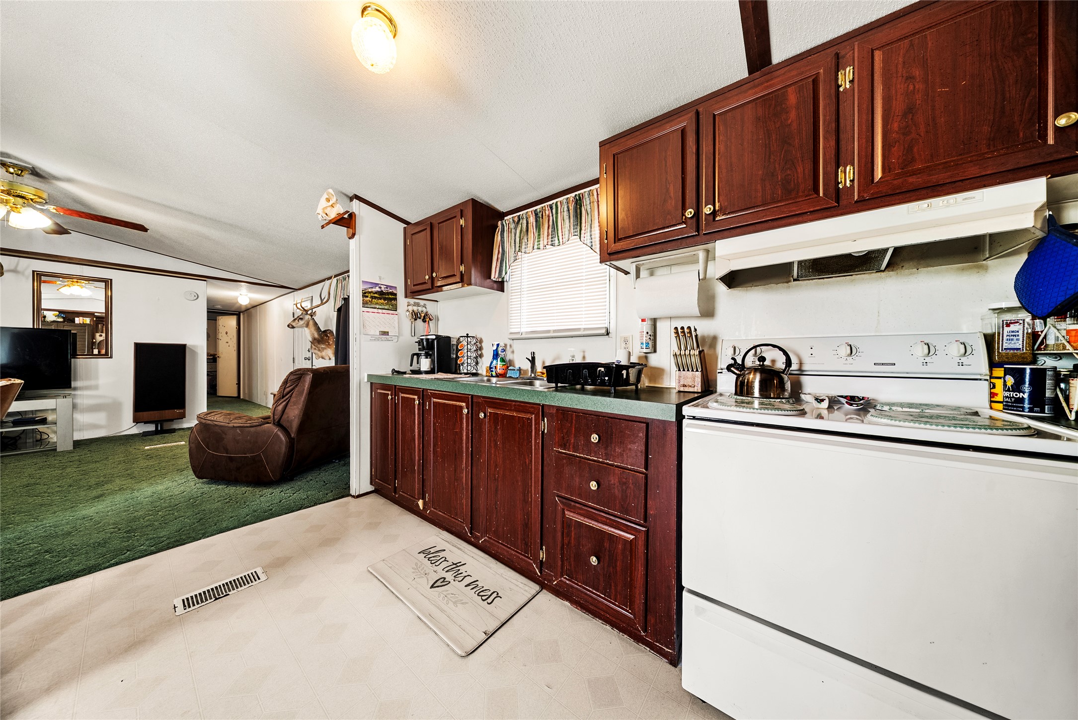 5101 County Road 463 Elgin, TX 78621 - Photo 38 of 38 a kitchen with granite countertop a stove sink and cabinets