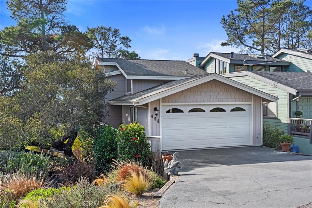 498 Croyden Lane Cambria, CA 93428 - Photo 1 of 68 a front view of a house with a yard and garage