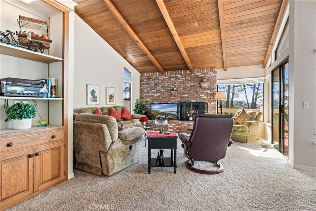498 Croyden Lane Cambria, CA 93428 - Photo 18 of 68 a living room with furniture a fireplace and a large window