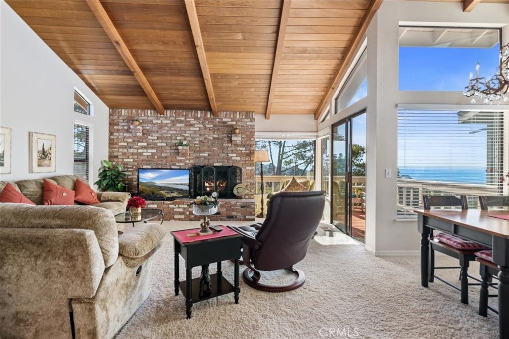 498 Croyden Lane Cambria, CA 93428 - Photo 19 of 68 a living room with furniture a fireplace and a table