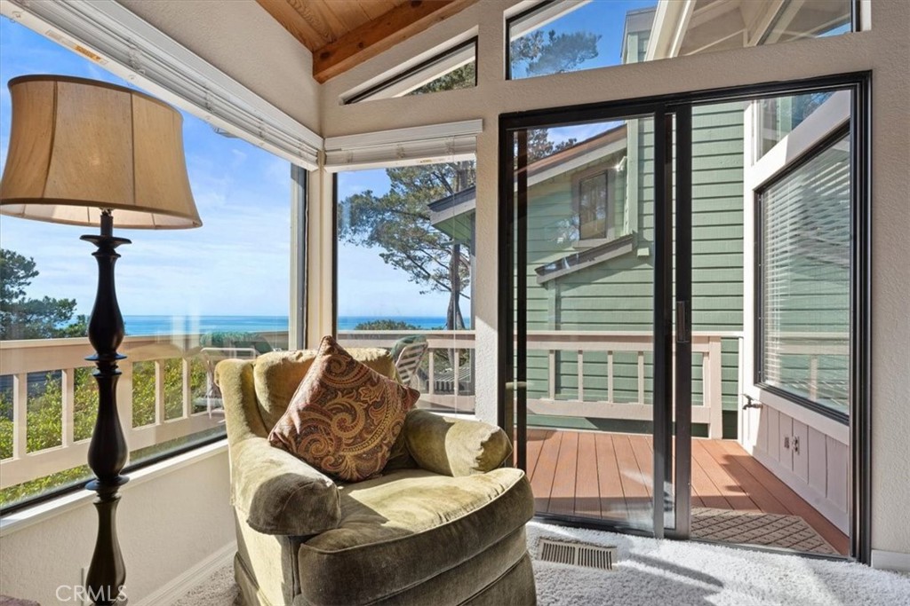 498 Croyden Lane Cambria, CA 93428 - Photo 23 of 68 a living room with furniture and a floor to ceiling window