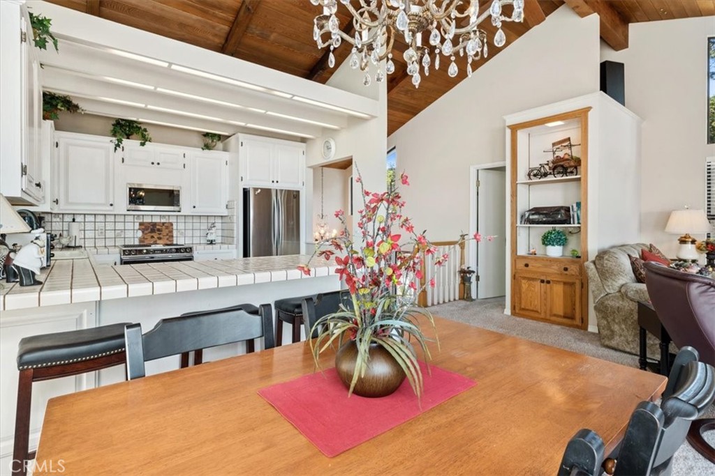 498 Croyden Lane Cambria, CA 93428 - Photo 30 of 68 a room with stainless steel appliances kitchen island granite countertop furniture and a livingroom view