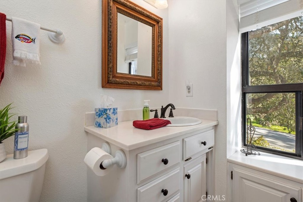 498 Croyden Lane Cambria, CA 93428 - Photo 37 of 68 a bathroom with a sink vanity and a mirror