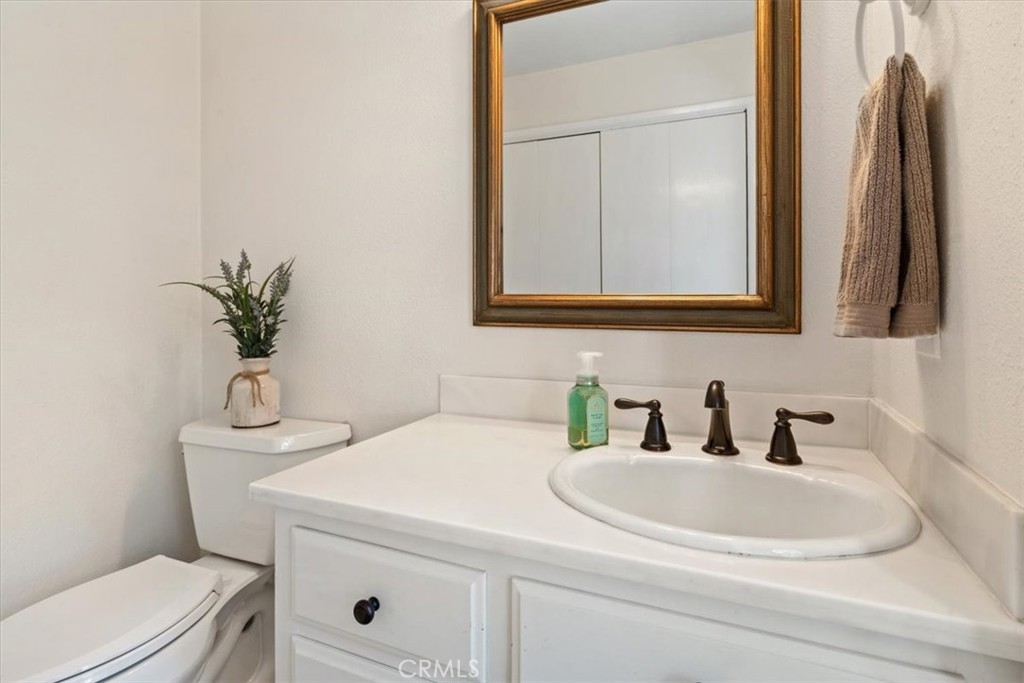 498 Croyden Lane Cambria, CA 93428 - Photo 56 of 68 a bathroom with a sink a toilet and mirror