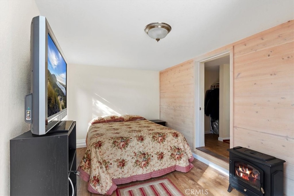 498 Croyden Lane Cambria, CA 93428 - Photo 64 of 68 a bedroom with a bed and a flat tv screen on the dresser