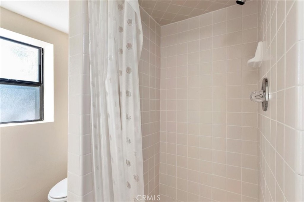 498 Croyden Lane Cambria, CA 93428 - Photo 66 of 68 a bathroom with a shower curtain and a toilet sink