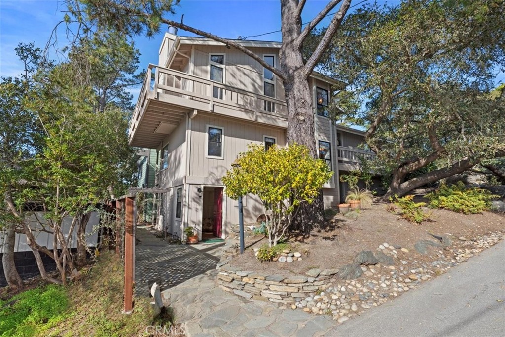 498 Croyden Lane Cambria, CA 93428 - Photo 7 of 68 a view of a white house with a yard and potted plants