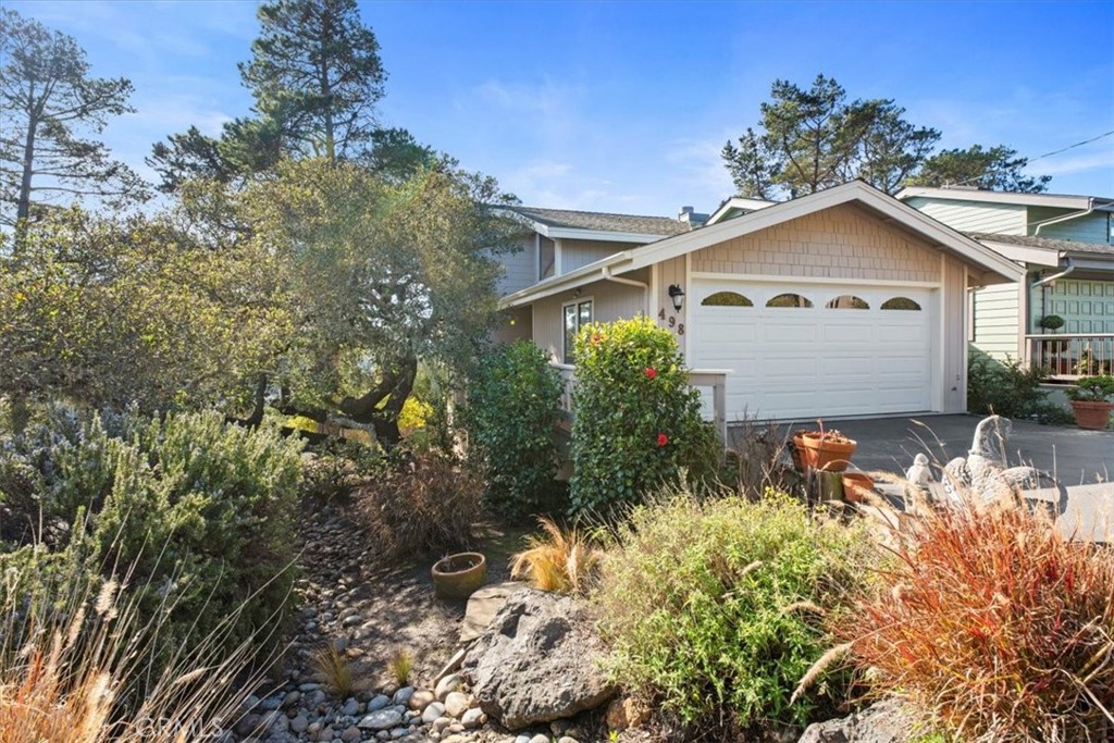 498 Croyden Lane Cambria, CA 93428 - Photo 9 of 68 a front view of a house with a yard and garage